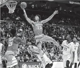  ??  ?? Syracuse’s
Malachi Richardson is fouled by Dayton’s Dyshawn Pierre as Syracuse’s
Tyler Roberson, left, and Dayton’s Scoochie Smith (11) watch during the second half of a Midwest
Region first-round game Friday in St. Louis. Richardson had 21 points...