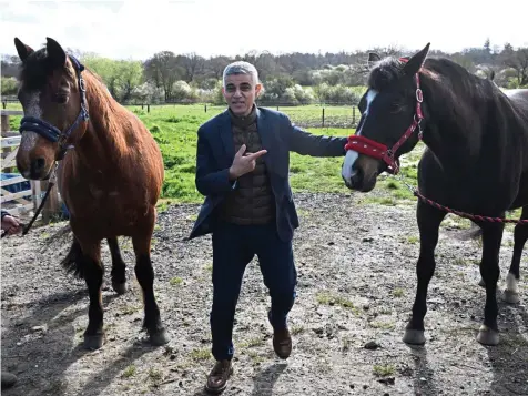  ?? LEON NEAL/GETTY ?? London Mayor Sadiq Khan on the campaign trail at a north London equine centre yesterday