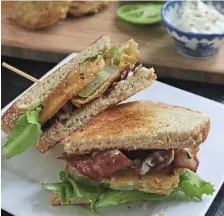  ?? Tns ?? CRUNCHY SUBSTITUTI­ON: Fried green tomatoes stand in for fresh red tomatoes in this BLT sandwich.