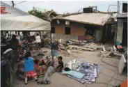  ?? Eduardo Verdugo / Associated Press ?? A family rests under a shelter in the middle of a street next to homes damaged in Tuesday’s quake.