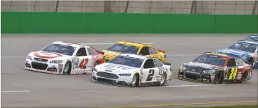  ?? Timothy D. Easley/AP ?? Kyle Larson (42), Brad Keselowsi (2), Joey Logano and Jeff Gordon (24) lead the pack into Turn 1 at the start of the NASCAR Sprint Cup auto race at Kentucky Speedway.