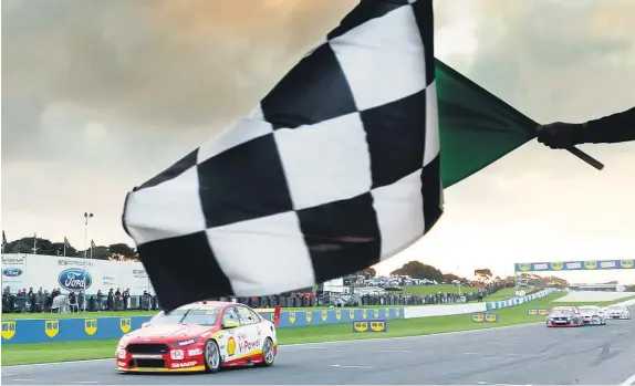  ?? Edge Photograph­ics ?? Kiwi Supercars driver Fabian Coulthard takes the chequered flag at Phillip Island yesterday.