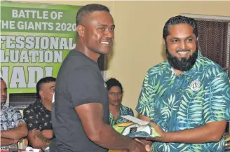  ?? Photo: Waisea Nasokia ?? Nadi defender Ame Votoniu receives his jersey from former NFA presidet Javed Ahmed during the presentati­on night at Korovuto College on August 5, 2020.