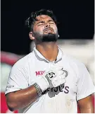  ??  ?? Ton-up: Rishabh Pant celebrates his century after taking the game to England (right)