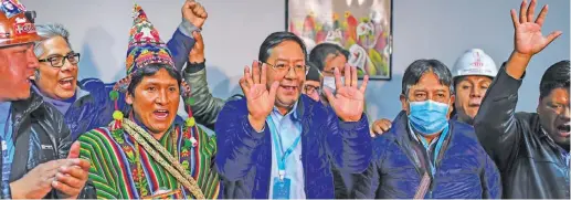  ?? RONALDO SCHEMIDT/AFP ?? Luis Arce (centre), of the Movement for Socialism party, celebrates the election ressults with running-mate David Choquehuan­ca (to his right).