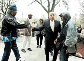  ?? SUZANNE TENNANT/POST-TRIBUNE ?? Lake County Assessor Jerome Prince greets voters and residents at a polling place in Gary on Tuesday. Prince won the Democratic Gary mayoral primary.