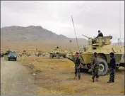  ?? Rahmatulla­h Nikzad Associated Press ?? AFGHAN FORCES arrive at the site of a deadly suicide bombing in Ghazni province on Sunday. Another attack occurred in Zabol province, in the south.