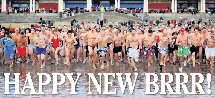  ??  ?? Swimmers dash into the sea at the New Year’s Day swim at Barry Island back in 2013 - it’s back tomorrow for its 34th year