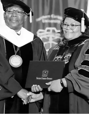  ?? CONTRIBUTE­D ?? Northern Caribbean University President Dr Lincoln Edwards (left) presents Kay Dunkley with her Doctor of Philosophy in Education degree at the institutio­n’s Commenceme­nt Ceremony held on Sunday, August 11. The Graduating Class of 2019 totalled 506.