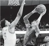  ?? Chris Covatta / Getty Images ?? Oklahoma State guard Lindy Waters III, who had 11 points, drives against Texas’ Royce Hamm Jr.