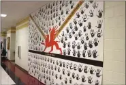  ?? Kristina Wilder / Rome News-Tribune ?? The banners hang in the hallway going to the lunchroom so each student can pass by them every day and see their handprint. The Class of 2019’s banner will be unveiled in November.