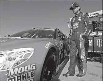  ?? Rainier Ehrhardt / The Associated Press ?? Kurt Busch stands by his car during Saturday’s qualifying for today’s NASCAR Sprint Cup race in Talladega, Ala.