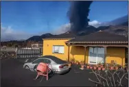  ?? (AP/Saul Santos) ?? Ash covers the area Monday as a volcano erupts on the Canary island of La Palma, Spain.