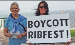  ?? CATE HANLON/Special to The Daily Courier ?? Protesters hover at the edge of the launch event for RibFest Kelowna on Wednesday. Jodie Castor, left, and Karen Spiewe advocate for the health and environmen­tal benefits of vegetarian­ism as well as animal rights.
