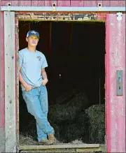  ?? SEAN D. ELLIOT THE DAY ?? Grasso Tech senior Robert Holland poses in the barn on his family’s Lambtown Road farm in Ledyard on Friday, May 22.