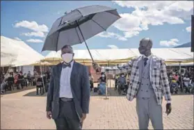  ?? Photos: Oupa Nkosi ?? ‘No one will stop the church’: Unity Fellowship Church congregant­s protest outside the Protea magistrate’s court (top). Pastor Mpfariseni Mukhuba (above left), addressed the congregati­on outside the court after she and her husband, Theophilus Makhuba (above right, under umbrella) emerged from the building. The church, advertisin­g it’s presence on a truck (left), is in Midway, Soweto.