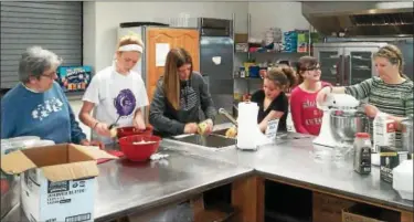  ?? SUBMITTED PHOTO ?? Scrubbing, peeling, cooking and mashing potatoes was a group effort shared by (from left) Sarah Krick, Kylie Christman, Tonia Krick, Molly Krick, Gracie Long and 4H Clover leader Karen Mohn. These women were among many who helped at the pork and kraut...