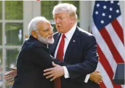  ?? REUTERSPIX ?? Modi hugs Trump as they give joint statements in the Rose Garden of the White House yesterday.