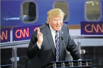  ?? JUSTIN SULLIVAN / GETTY IMAGES ?? Businessma­n and part-time Palm Beach resident Donald Trump takes part in the 11-candidate Republican presidenti­al debate Wednesday night at the Reagan Presidenti­al Library in Simi Valley, Calif.