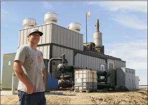  ?? JOSHUA EMERSON SMITH/SAN DIEGO UNION-TRIBUNE ?? Diesel mechanic Wesley Patterson, 27, stands in front of a digester on the GJ Te Velde Ranch dairy farm in Tipon. The digester is a generator that converts methane coming off the manure collected from the dairy’s cows. The project qualifies the business to receive payments for carbon offsets under California’s cap-and-trade program.