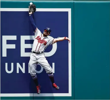  ?? PATRICK MCDERMOTT/GETTY IMAGES ?? Braves outfielder Ender Inciarte is unable to catch a drive by Juan Soto of Washington during the third inning in Game 1 of a doublehead­er Tuesday at Nationals Park in Washington.