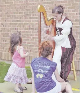  ?? COURTESY PHOTO ?? Chester Gap resident Brigid Sladky plays the harp at Chelsea Academy's recent Medieval Festival.