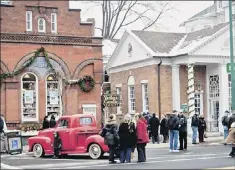  ??  ?? Period vehicles will re-create Norman Rockwell’s “Christmas on Main Street” in Stockbridg­e, Mass., on Sunday.