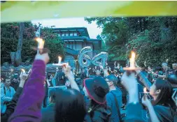 ?? JESSE WINTER TORONTO STAR FILE PHOTO ?? Protesters hold candles outside the Chinese Consulate in Vancouver in 2019 during a vigil to mark the 30th anniversar­y of the Tiananmen Square massacre. For several years the consulate hosted a cocktail party for B.C. municipal politician­s during their annual convention — a tradition that ended last year.