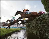 ?? Jon Super / Associated Press ?? Noble Yeats ridden by Sam Waley-Cohen, at center, clears the water jump on the way to winning Grand National on Saturday.