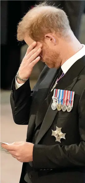  ?? ?? Overcome with emotion: Prince Harry wipes his eyes