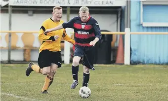  ??  ?? Boldon Colliery Old Barrel take the ball away from Ivy Legends.