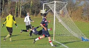  ??  ?? Paul Carmichael slides in to connect with this Brian MacKay’s cross to open the scoring.