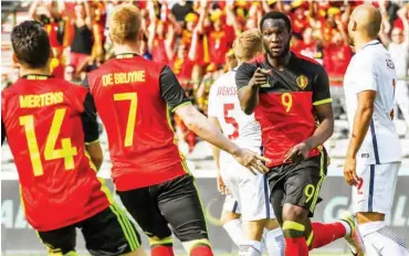  ??  ?? Romelu Lukaku celebrates with Belgian teammates after scoring a goal