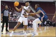  ?? (Arkansas Democrat-Gazette/Justin Cunningham) ?? UALR guard Myron Gardner (left) looks to pass the ball Thursday during the Trojans’ 88-74 victory over Tennessee-Martin at Simmons Bank Arena in North Little Rock. More photos at arkansason­line.com/1230menual­r/.