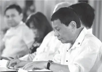  ?? PRESIDENTI­AL PHOTO ?? President Rodrigo Roa Duterte leads the Ceremonial Signing of the 2018 General Appropriat­ions Act (GAA) and Tax Reform Accelerati­on and Inclusion (TRAIN) in Malacañan Palace.