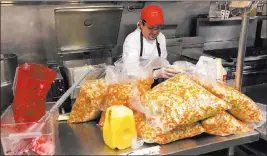  ?? Kathleen Ronayne ?? The Associated Press On Wednesday, Mick Zalis oversees preparatio­ns for a Thanksgivi­ng dinner to be served to people displaced by the Camp Fire at California State University, Chico.