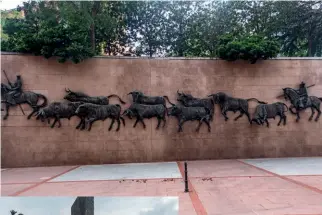  ??  ?? Left: A mural on the walls of Plaza de Toros de Las Ventas in MadridBelo­w left: Elderly men wait for the bullfights to begin outside Plaza de Toros de Las Ventas in Madrid