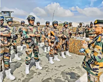  ?? - PTI ?? General M.M. Naravane interacts with troops and compliment­s them for their high morale and high state of operationa­l preparedne­ss.