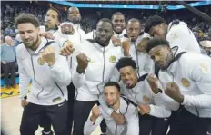  ?? — USA Today Sports ?? Golden State Warriors players pose with their rings during the ring ceremony before the game against the Oklahoma City Thunder.