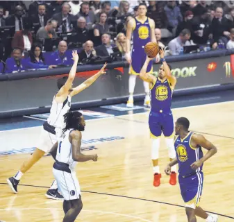  ?? Ronald Martinez / Getty Images ?? Stephen Curry launches a jump shot against the Mavericks. He hit 11 3-pointers and scored 48 points, figures that could help him rejoin the conversati­on about potential MVP candidates.