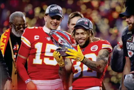  ?? ASSOCIATED PRESS ?? KANSAS CITY CHIEFS’ TYRANN MATHIEU AND PATRICK MAHOMES (15) HOLD UP THE LAMAR HUNT TROPHY after the AFC Championsh­ip football game against the Tennessee Titans on Sunday in Kansas City, MO.