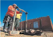  ?? /Simphiwe Nkwali ?? No trickle down: Ana Mere, right, and Safira Melthaf collect water from a borehole in the miningaffe­cted community of Oersonskra­al in the North West.