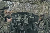  ?? MAURICIO LIMA THE NEW YORK TIMES ?? Ukrainian artillery crew members prepare to fire toward Russian-held territory in the Zaporizhzh­ia region of southeaste­rn Ukraine last month. Ukrainian troops along most of the 600-mile front line remain optimistic but physically exhausted, with Russian forces now on the offensive in most regions.