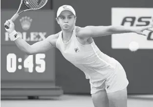  ?? MARTA LAVANDIER/AP ?? Ashleigh Barty returns to Victoria Azarenka during the Miami Open tennis tournament Monday in Miami Gardens.