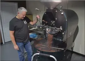  ?? PETE BANNAN - MEDIANEWS GROUP ?? Brian Niles grinds coffee at his Coffee Roaster Wholesale business on Eagle Road in Haverford.