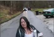  ??  ?? Yvonne Ash carries back to her house a CPR kit and a supply of the overdose reversal medication naloxone after a visit from the Quick Response team, which visits everyone who overdoses to offer help, Monday in Branchland, W.Va., just days after Ash’s son overdosed,