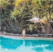  ?? ?? K’gari’s Lake Mckenzie, top, picture: Instagram @tripinavan; Kingfisher Bay Resort atrium, right; Kingfisher Bay Resort pool, picture: @_aswewander; and, far left, K’gari is the world’s largest sand island.