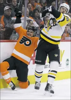  ?? Associated Press ?? Riley Sheahan, right, fends off Philadelph­ia’s Scott Laughton along the boards Wednesday night in Philadelph­ia.