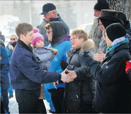  ?? AL CHAREST ?? Edouard Maurice is greeted by supports as he makes his way into the Okotoks Provincial Court Building on Friday. The local landowner faces criminal charges after an incident in which shots were fired when he confronted people on his property at night.