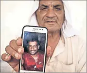  ?? [MAYA ALLERUZZO/THE ASSOCIATED PRESS] ?? Jassim Mohammed Ibrahim shows a picture of his 30-yearold son, Ali Thamin Jassim Mohammed Ibrahim, who was arrested by Iraqi security forces who cited Iraq’s Article 4 terrorism law, at Daquq Camp near Kirkuk, Iraq. The man does not know where is son...